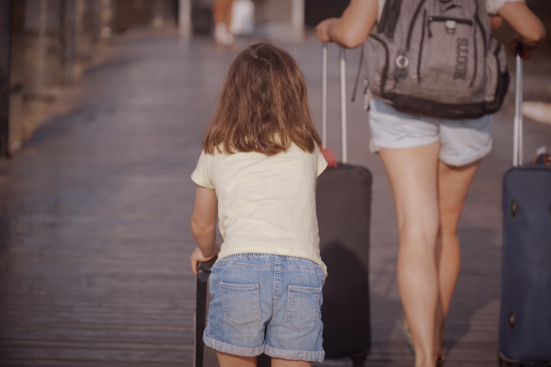 A parent and child traveling with luggage