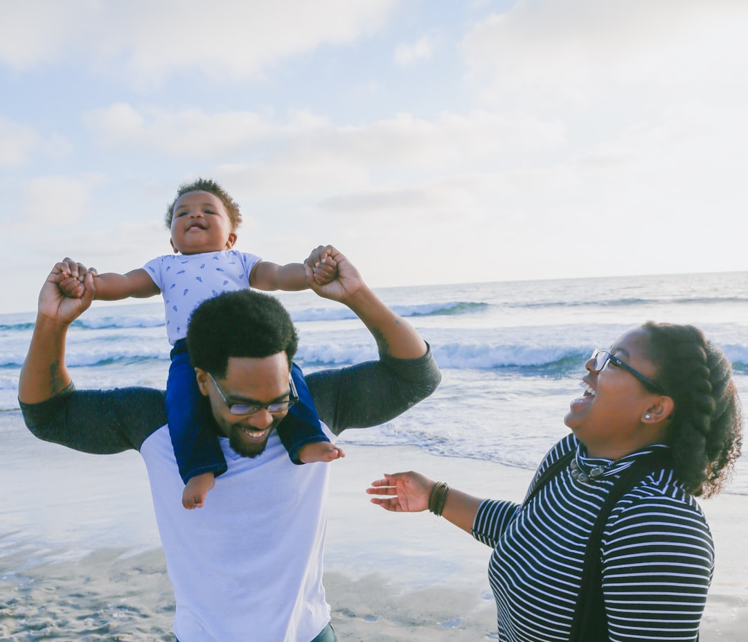 Parents and a child enjoying a family beach vacation