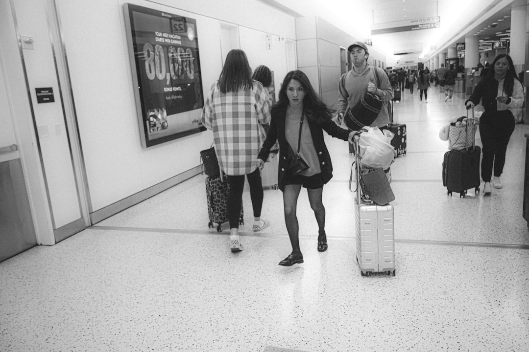 A family walking through an airport with luggage